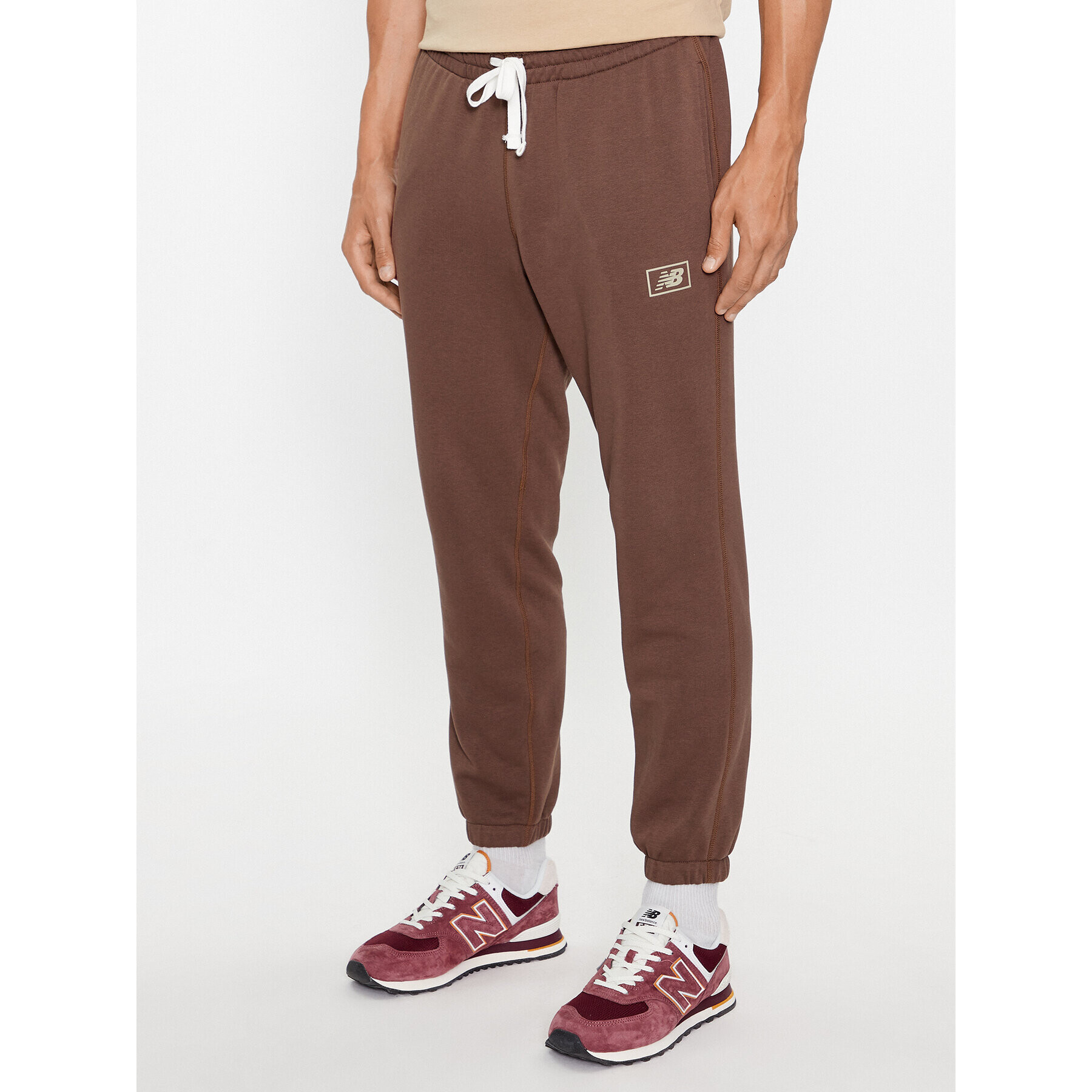 New Balance Долнище анцуг NB Essentials Sweatpant MP33509 Кафяв Regular Fit - Pepit.bg